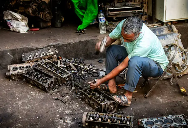 Mechanic repairing machinery or equipment in workshop